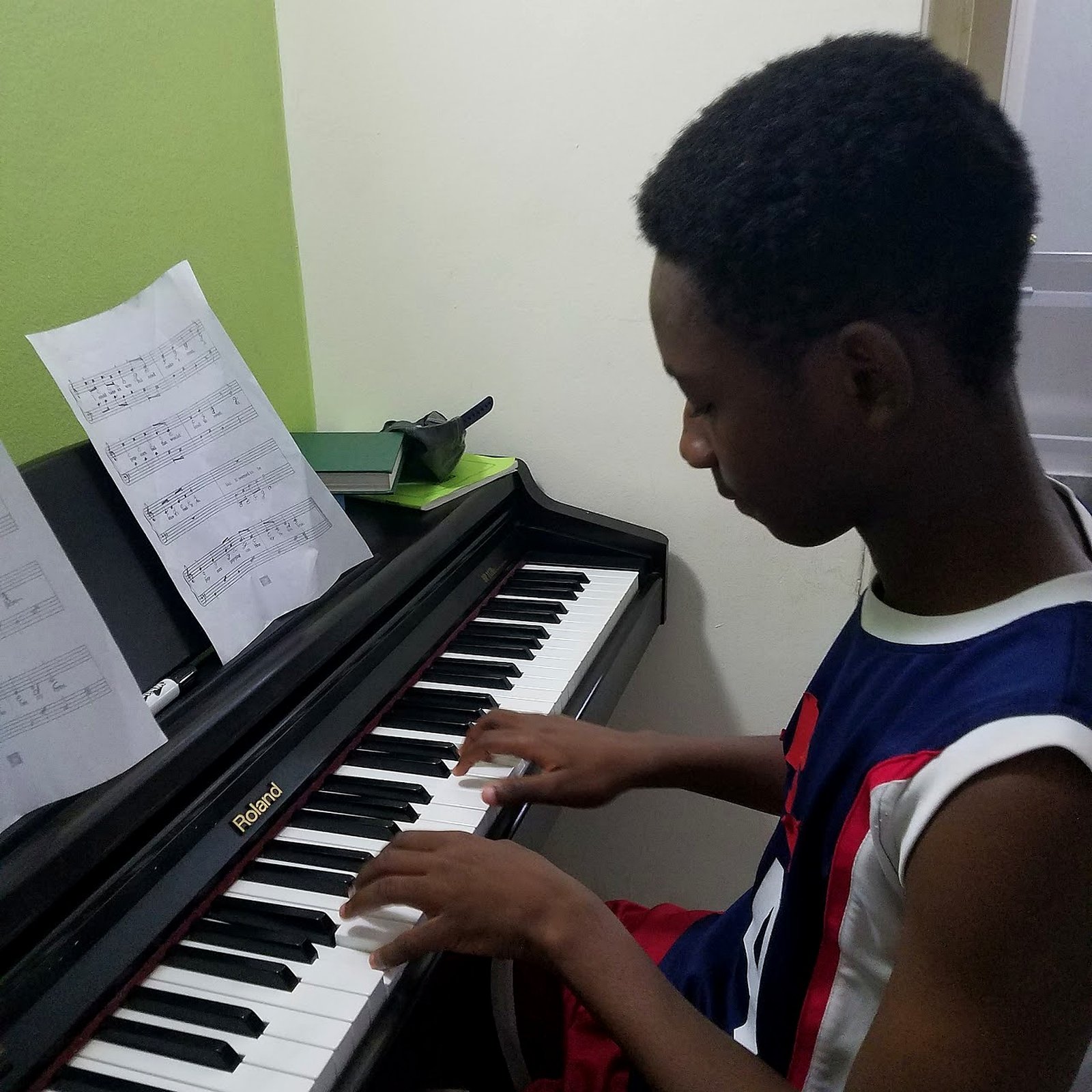 Student practicing piano at Giggle School